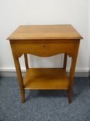 A NEAT LIGHT OAK OBLONG TOPPED CUTLERY CANTEEN having a shaped front apron and base shelf