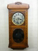 A VINTAGE OAK CASED WALL CLOCK having a twin glazed panel door, interior circular silvered dial