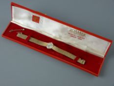 A LADY'S NINE CARAT GOLD ENCASED CIRCULAR DIAL ROAMER WRISTWATCH with incorporated bark style