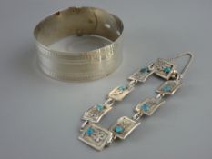 A WIDE SILVER BELT SHAPED BANGLE and a bracelet of floral panels, each set with a turquoise bead,