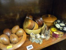 Parcel of carved wooden eggs, wooden bowls, paperweight etc