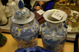 Two blue and white Oriental decorated vases, one lidded