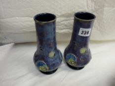 Pair of Royal Doulton chimney type vases, blue ground with raised decoration and bulbous bases