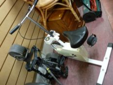 Tunturi vintage exercise machine and an electric Powakaddy golf trolley