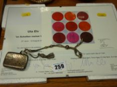 Silver vesta on a tasselled white metal chain and an art exhibition framed print and flyer