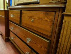 Victorian pitch pine chest of two short over two long drawers on bun feet