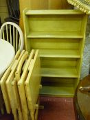 Light wood bookshelf, set of four folding tables in stand and a mid Century standard lamp with