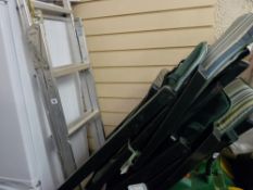 A frame ladder and two garden loungers