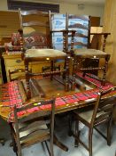A reproduction oak extending oval dining table with twin-pedestals & 4+2 railback bobbin supported