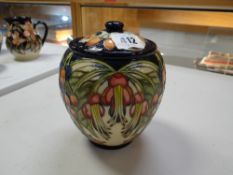A Moorcroft biscuit barrel in the Puriri Tree pattern from a New Zealand collection, designed by