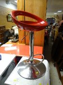 A modern retro-style chrome support rotating bar stool