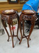 A pair of Oriental-style planter pedestals with vein pink marble inserts