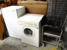 A retro wheelchair, a Philco self condensing washer dryer, a retro Electrolux freezer
