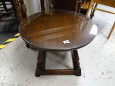 A vintage dark oak circular topped coffee table