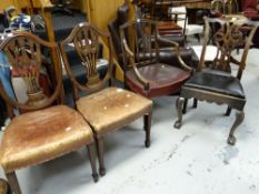 A pair of shield back antique dining chairs with leather stuff over seats together with two