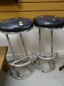 A pair of chrome supported bar stools