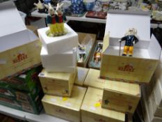 Eight boxed Royal Doulton Rupert figures