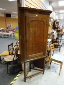 Antique oak corner cupboard with a four-shelf, two-drawer interior on a later turned leg stand