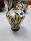 A small Moorcroft baluster vase in the Ode to May pattern, dated 2005
