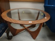 A pair of vintage blue upholstered wingback armchairs & a retro glass topped circular coffee table