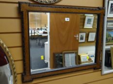 A vintage carved oak framed bevelled wall mirror