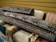 A large Persian multi-coloured wool carpet & another together with a roll of cut carpet