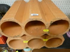 Two three bottle clay wine racks