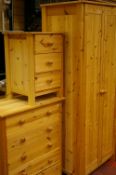 Modern pine three piece bedroom suite of two door wardrobe, five drawer chest and three drawer