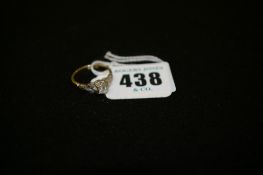 Eighteen carat gold dress ring with small centre diamond and flanking leaf set tiny diamonds, 3.4