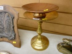 Brass kettle stand and a shallow copper pedestal dish