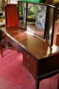 Long Stag Minstrel triple mirrored dressing table, a single door cupboard and a light wood stool