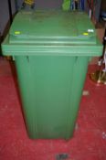 Large green wheelie bin and plant pot contents