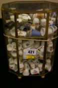 Quantity of collector's thimbles in a brass and glass display case