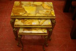 Nest of three onyx and brass side tables