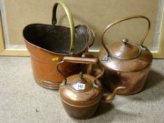 Two copper kettles and a beaten copper helmet coal scuttle with brass handle