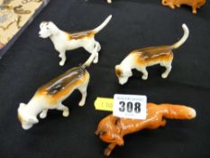 Three Beswick hunting hounds and a fox