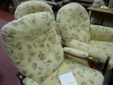 Pair of floral decorated armchairs and a similarly upholstered reclining chair by Cintique