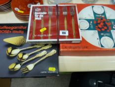 Three boxes of plated table cutlery