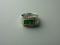 A FOURTEEN CARAT WHITE GOLD EMERALD & DIAMOND DRESS RING having three square faceted yellow green