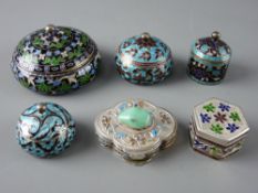 A STAMPED SILVER PILL BOX & FIVE OTHERS in unmarked white metal, all six enamel decorated, one