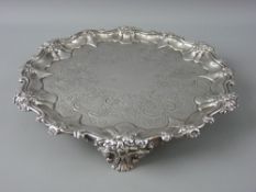 A CIRCULAR SILVER TRAY with floral scrolled border and bright cut floral decoration to the base (one