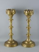 A PAIR OF BRASS ALTAR CANDLESTICKS having 11.5 cms candleholders with castellated decoration, triple