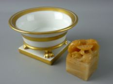 A HEREND CIRCULAR SMALL CHINA BOWL, plain white with gilt decoration and with four claw supports