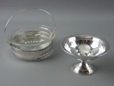 A CIRCULAR PRESSED GLASS BUTTER DISH in a pierced silver liner with three ball feet and centre