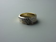 AN EIGHTEEN CARAT YELLOW & WHITE GOLD BLACK & WHITE DIAMOND SET DRESS RING having twenty two tiny