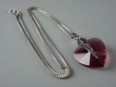 AN ARTIST'S DESIGNED HEART SHAPED RED SWAROVSKI CRYSTAL with silver and black decoration and with