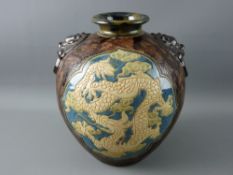 A CIRCA 1900 BULBOUS VASE decorated in the Oriental style, incised swirl decoration with mottled