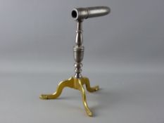 A GEORGIAN BRASS & POLISHED IRON GOFFERING IRON having turned baluster decoration on shaped tripod