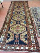 A GOOD SIZE RED GROUND EASTERN WOOLLEN CARPET with large floral decorated central medallion and wide