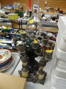 A pair of metallic candlestick holders & a vintage oil lamp